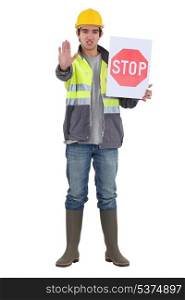 craftsman holding a stop sign