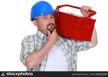 craftsman holding a tool box and touching his chin
