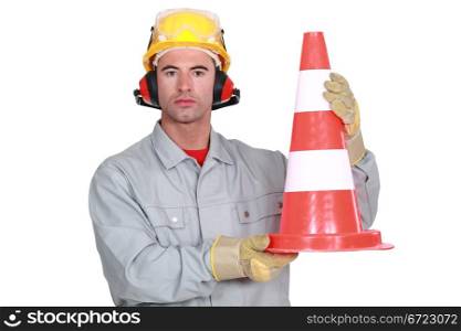 craftsman holding a traffic cone