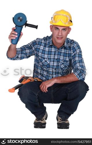 craftsman holding an electric saw