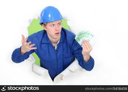 craftsman holding bills and looking surprised