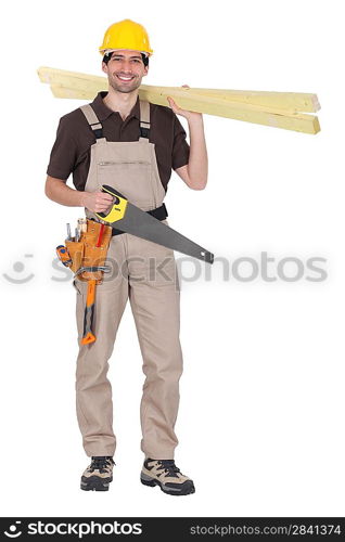 craftsman holding wooden boards and a saw