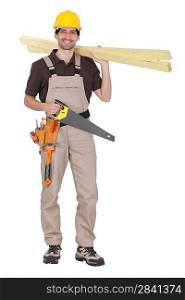 craftsman holding wooden boards and a saw