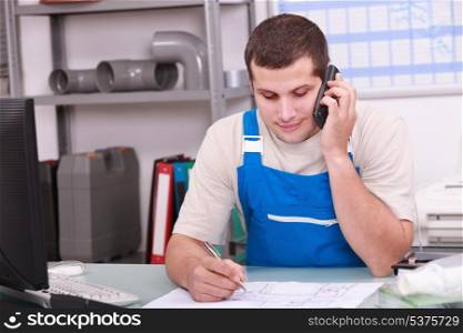 Craftsman in office on phone