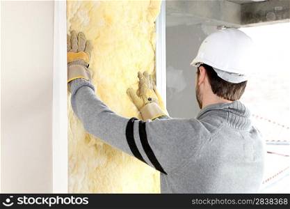 craftsman insulating a wall