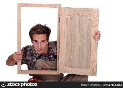 craftsman looking through a window frame