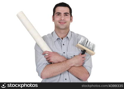 craftsman painter holding a wallpaper and a brush