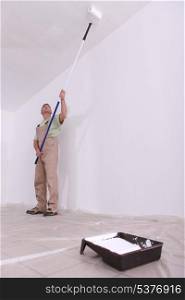 craftsman painting a ceiling