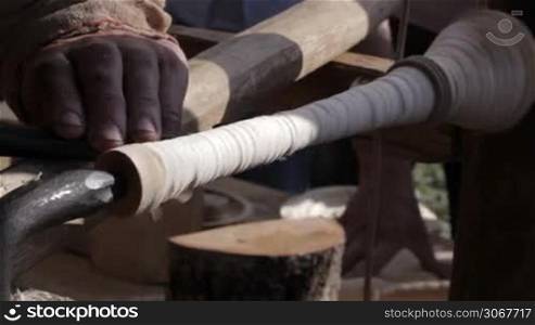 Craftsman turning wood on a manual vintage lathe