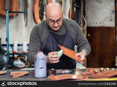 craftsman working the leather in his small workshop