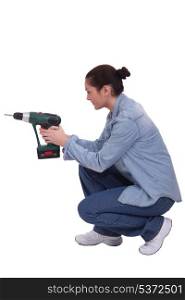 craftswoman holding a drill