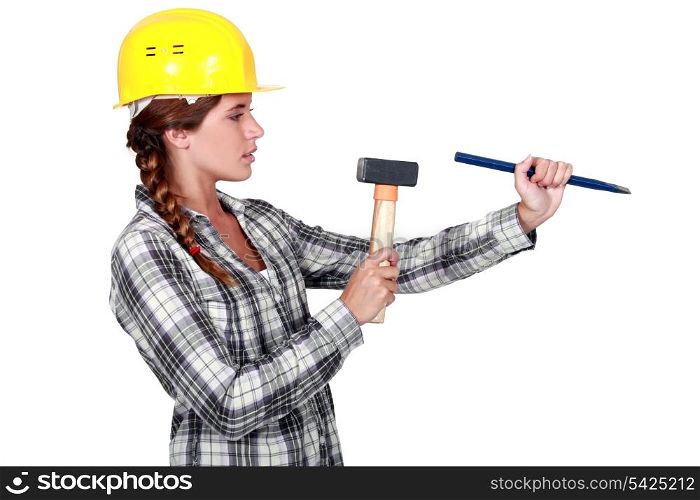 craftswoman holding a wedge and a hammer