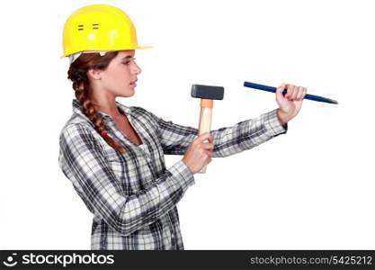craftswoman holding a wedge and a hammer