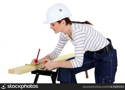 Craftswoman measuring a board