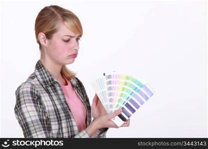 craftswoman painter holding a color chart