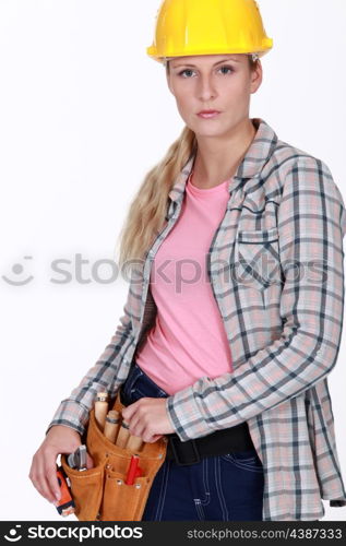 craftswoman putting a tool in her belt