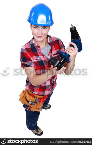 craftswoman putting the charger to a cordless drill