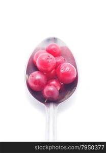 cranberries and spoon on a white background
