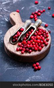 cranberry on wooden board and on a table