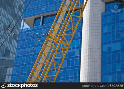 Crane and building under construction in Tel-Aviv. Industrial construction crane in Israel.