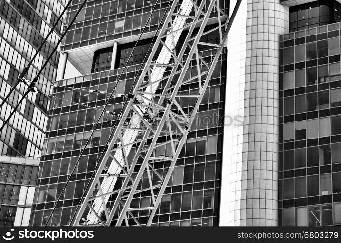 Crane and building under construction in Tel-Aviv. Industrial construction crane in Israel. Black and White Picture