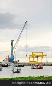 Crane for lifting a load up and down the ship in deep water harbor area of Thailand