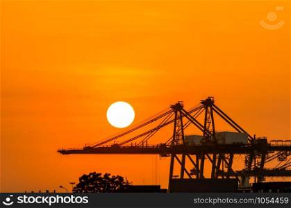Crane in the industrial port on sunset background