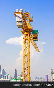 Crane is used in the construction of high buildings for tool of large industry under the blue sky and white clouds.