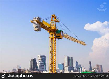 Crane is used in the construction of high buildings for tool of large industry under the blue sky and white clouds.