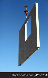 Crane lifting concrete wall