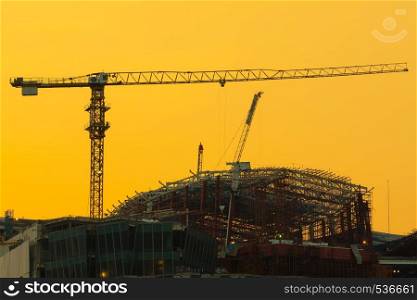 crane on the building, the construction of a high-rise building in the evening