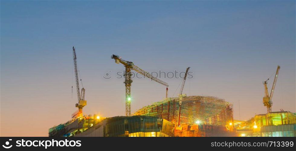 crane on the building, the construction of a high-rise building in the evening