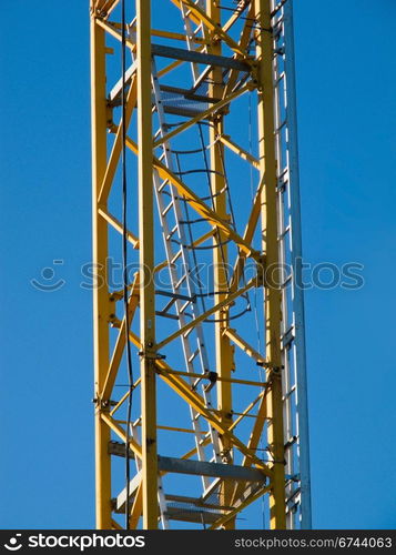 Crane stairs detail. Detail of the stairs of a yellow hoisting tower crane