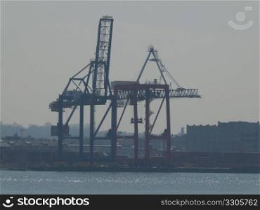 crane standing in the harbor waiting for the next cargo ship