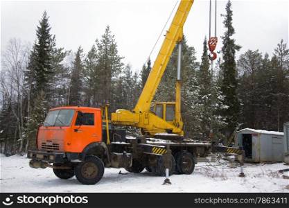 crane working in the woods in winter. The snow. Taiga.