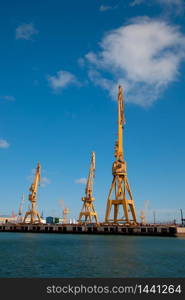 Cranes of the dockyards of Cadiz in a sunny day. Dockyards of Cadiz