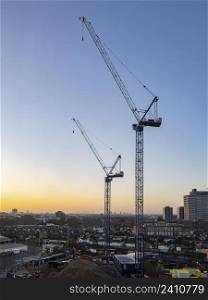 Cranes on a construction site in central London in the United Kingdom.