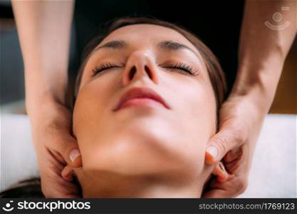 Cranial osteopathy massage. Therapist massaging woman&rsquo;s head.. Cranial Osteopathy. Therapist Massaging Woman&rsquo;s Head.