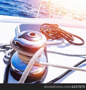 Crank handle of sailboat, detail of yacht, holder for rope, bright sunset in the sea, summer holidays, luxury water transport, yachting sport concept