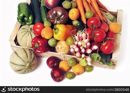 crates of fruit and vegetables on white background in studio.