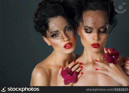 Craving. Aspiration. Two Seductive Fervent Women with Flowers