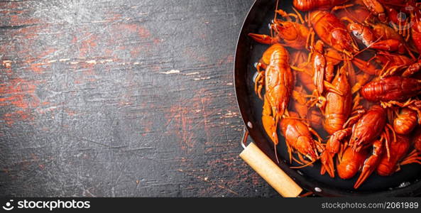 Crayfish are boiled in a saucepan. Against a dark background. High quality photo. Crayfish are boiled in a saucepan.