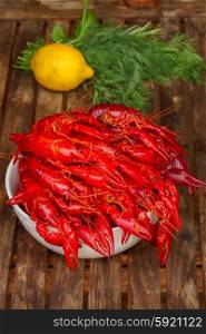 Crayfish. red boiled Crayfish in bowl on wooden table with dill and lemon