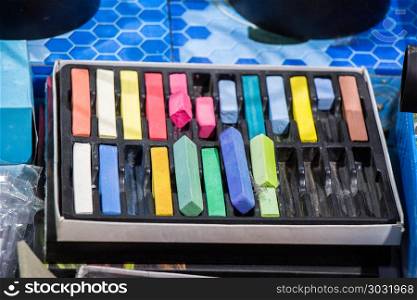 Crayons of various color in a box. Crayons of various color in a box on a canvas