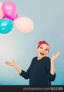 Craziness and lots of fun. Cute crazy joyful girl playing with colored balloons. Blonde playful retro style woman feel craze.. Smiling crazy girl having fun with balloons.