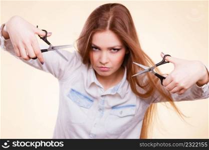 Craziness of professional hairdresser. Hair hygiene. Girl with scissors making crazy funny face preparing herself to cutting styling new image hairdo coiffure.. Crazy girl with scissors. Hairdresser in action.