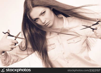 Craziness of professional hairdresser. Hair hygiene. Girl with scissors making crazy funny face preparing herself to cutting styling new image hairdo coiffure.. Crazy girl with scissors. Hairdresser in action.