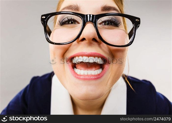 Crazy bizarre business woman or teacher wearing nerd eyeglasses. Female being energetic motivated, wide angle view.. Close up of happy crazy business woman