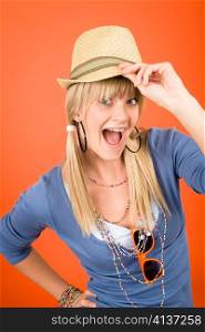 Crazy blond girl wear hat shouting on orange background
