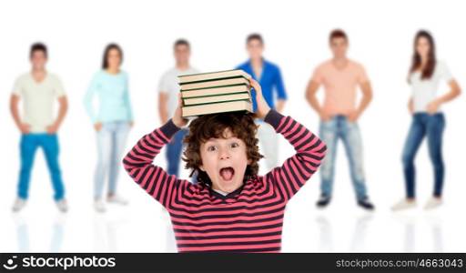 Crazy child with books on his head and people unfocused background